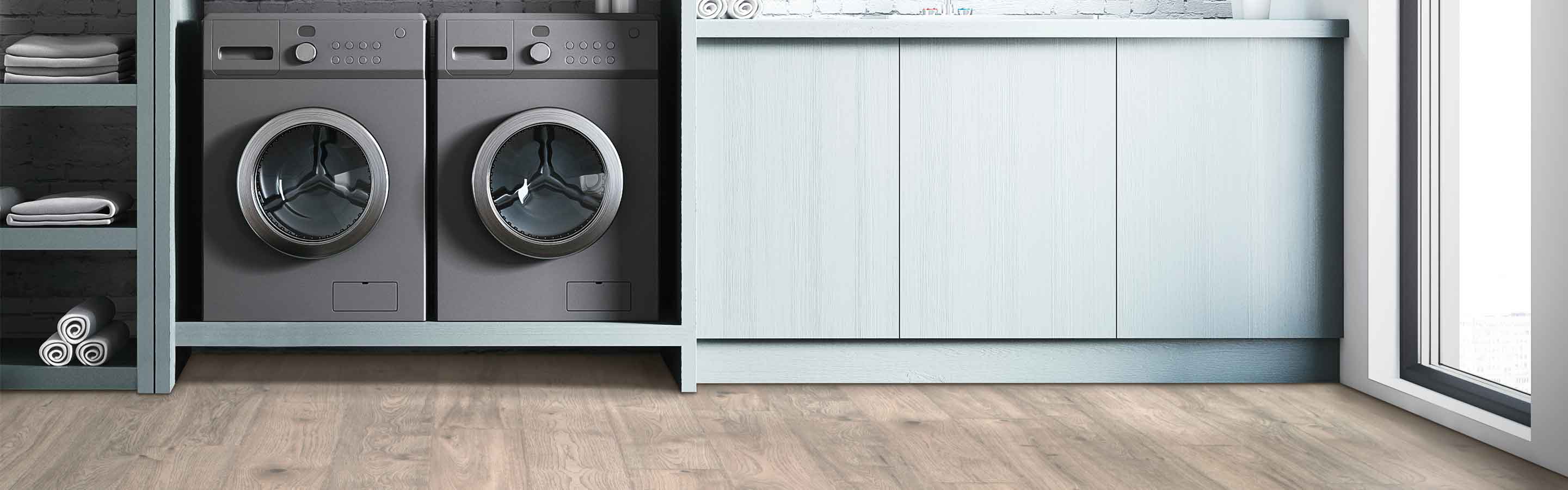 Laminate flooring in a laundry room with a washer and dryer